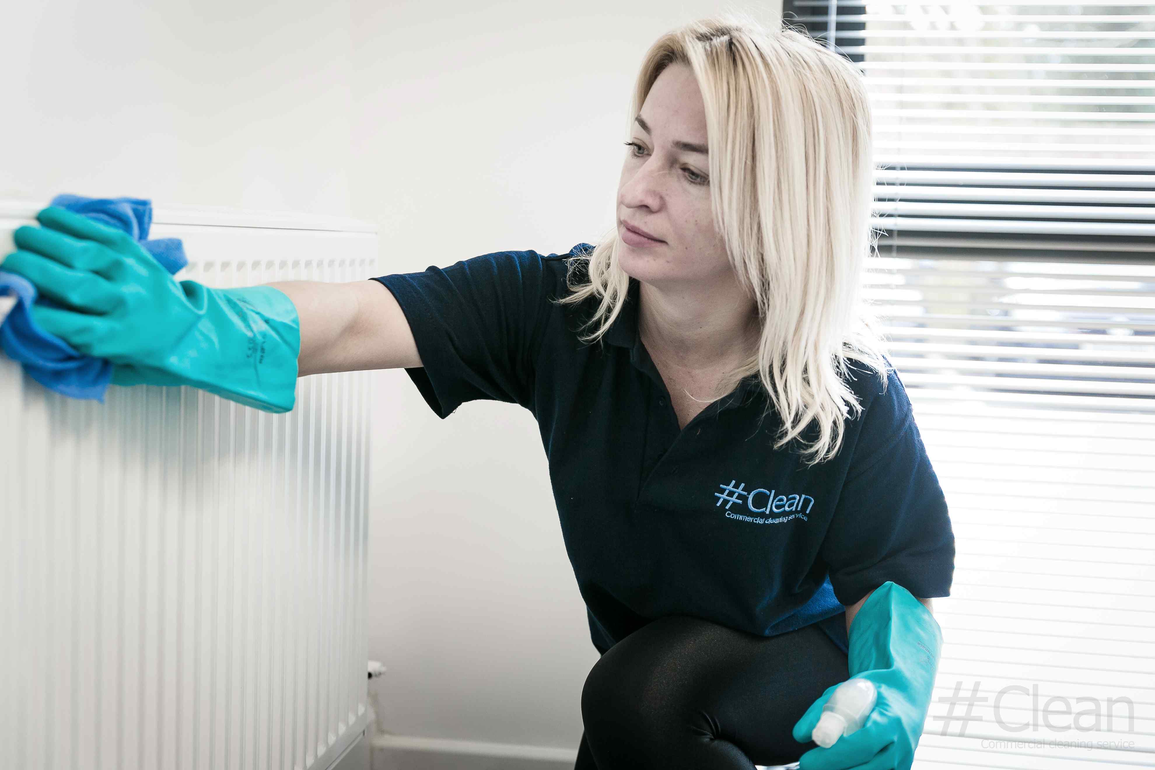 Woman Wiping A Radiator Clean