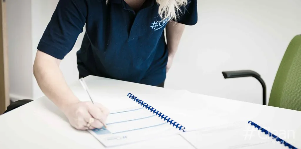blonde woman filling in cleanliness report